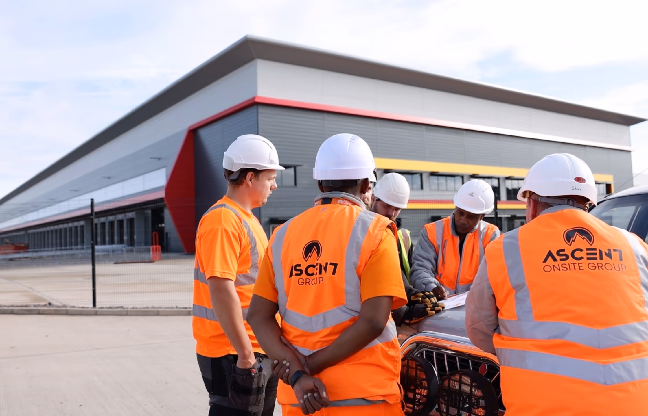 AOG operatives reviewing site plans outside a warehouse development
