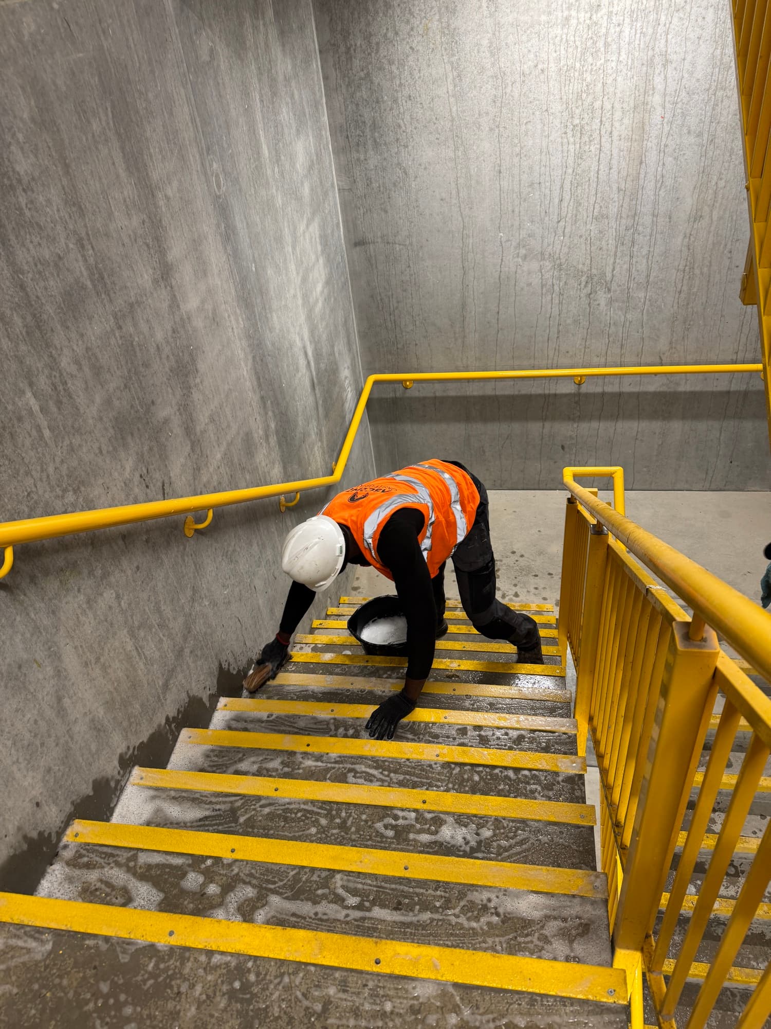 AOG cleaning operative at work on a stairwell